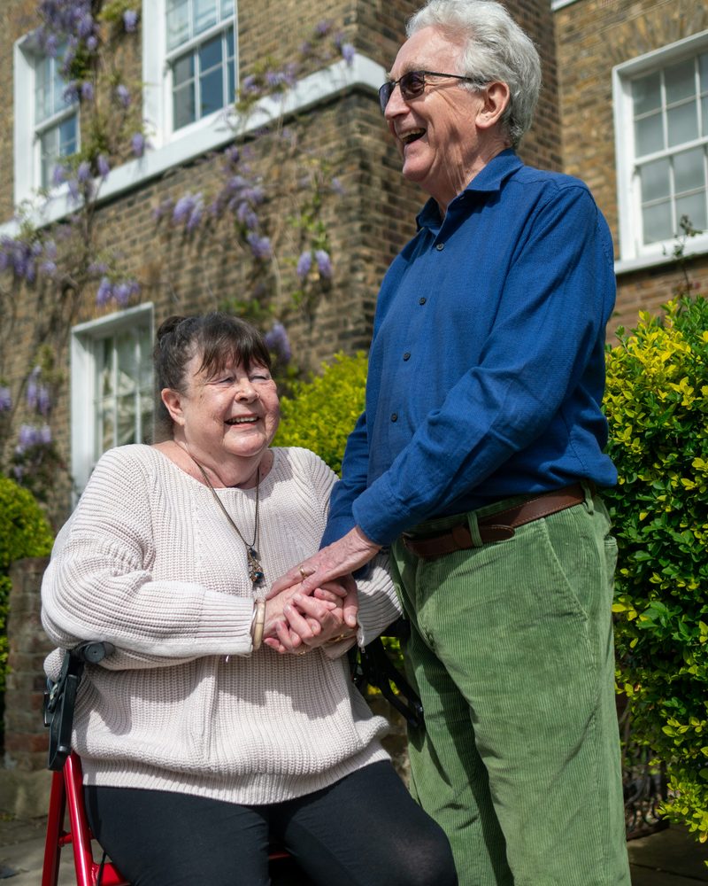 An older couple holding hands outdoors